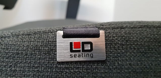 Marking for Furniture and Interior Accessories - Not always is it necessary to use adhesive version for labels. - The company LD seating utilizes the option of stitching a 3D aluminum badge with an embossed design to their upholstered chairs.
