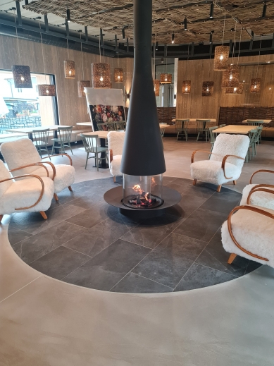 Fireplace with panoramic glass in the heart of a renovated farmhouse